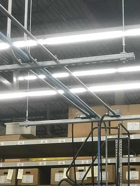 Conduit runs across a high-bay ceiling by Elite Electric
