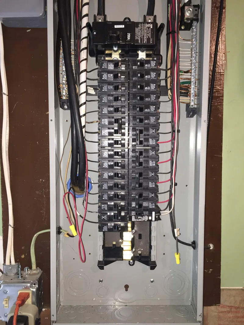 Open 200 amp electrical panel with clean breaker work by Elite Electric